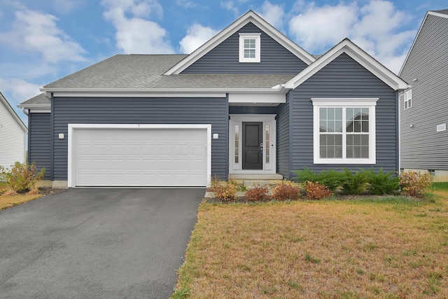 single story home with a front lawn, driveway, a shingled roof, and an attached garage
