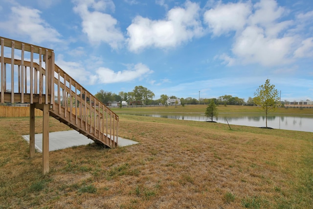 view of yard with a water view and stairway