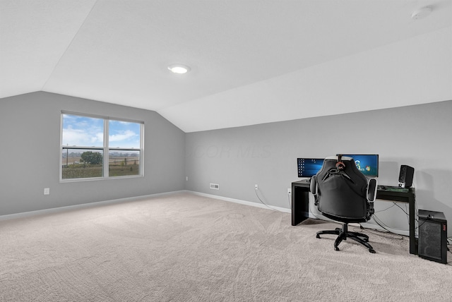 office space with carpet floors, baseboards, and vaulted ceiling