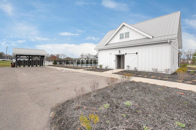 exterior space featuring an outbuilding and uncovered parking