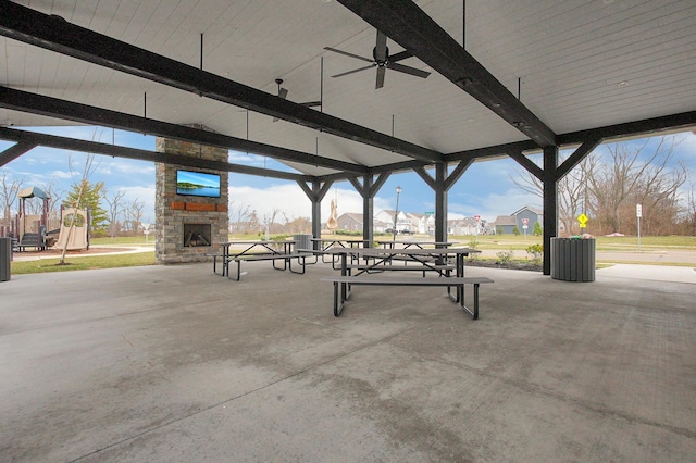view of patio / terrace featuring an outdoor stone fireplace