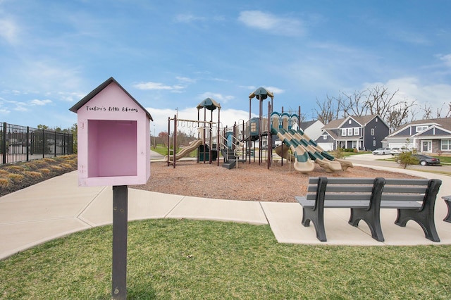 communal playground with a residential view, fence, and a yard