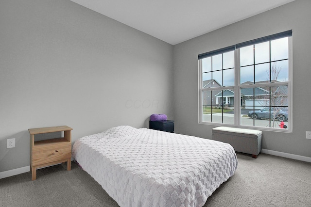 carpeted bedroom featuring baseboards