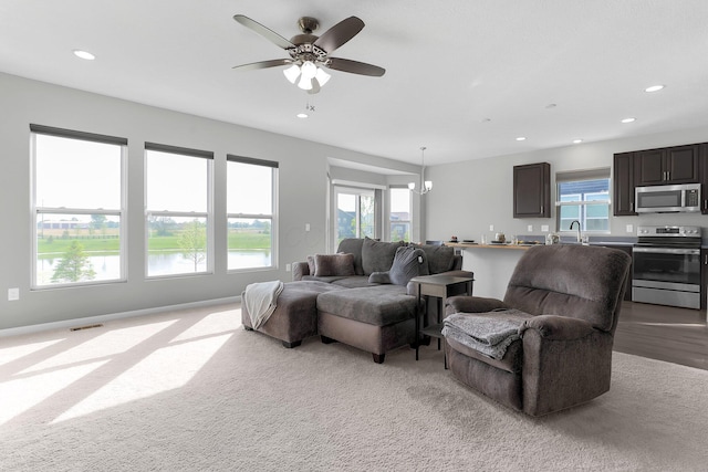 7 Erin Hills Rd, Commercial Point, OH 43116 - living area with plenty of natural light, light colored carpet, recessed lighting, a water view, and ceiling fan