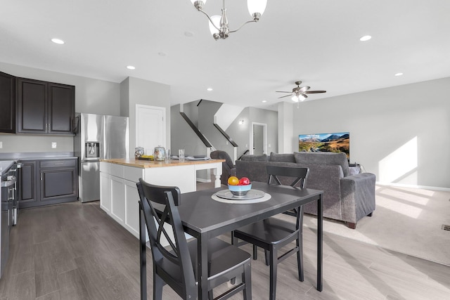 7 Erin Hills Rd, Commercial Point, OH 43116 - dining room featuring wood finished floors, recessed lighting, a ceiling fan, stairs, and a chandelier