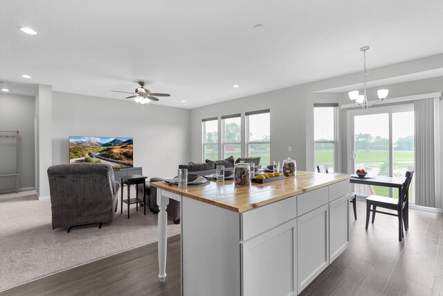 7 Erin Hills Rd, Commercial Point, OH 43116 - kitchen with butcher block counters, open floor plan, wood finished floors, hanging light fixtures, and a center island