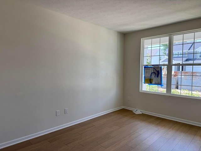 3780 Brody Dr Lot 187, Grove City, OH 43123 - spare room featuring a textured ceiling, dark wood finished floors, and plenty of natural light