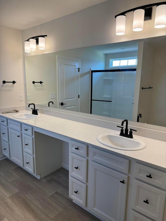 3780 Brody Dr Lot 187, Grove City, OH 43123 - bathroom featuring double vanity, wood finished floors, and a shower with shower door