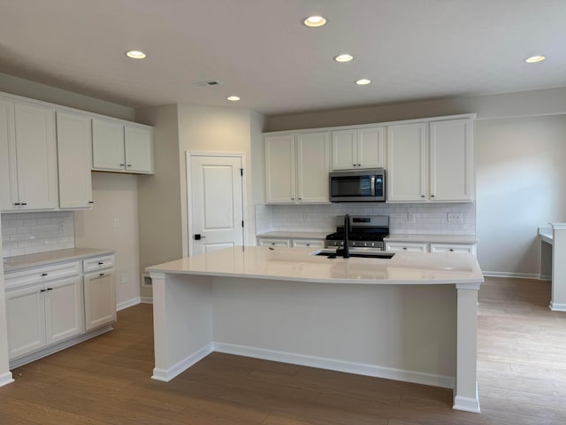 3780 Brody Dr Lot 187, Grove City, OH 43123 - kitchen featuring stainless steel appliances, decorative backsplash, recessed lighting, light wood-style flooring, and white cabinetry