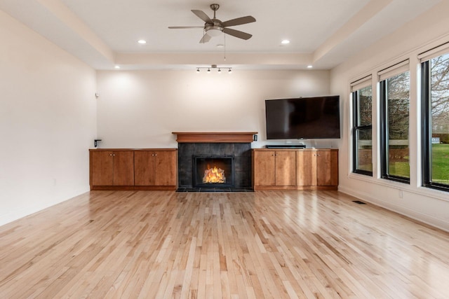 4175 Bangle Ct, Dublin, OH 43016 - unfurnished living room featuring a tiled fireplace, ceiling fan, light wood finished floors, and recessed lighting