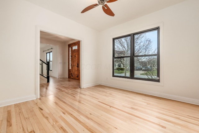 4175 Bangle Ct, Dublin, OH 43016 - unfurnished room featuring light wood-type flooring, ceiling fan, baseboards, and stairs