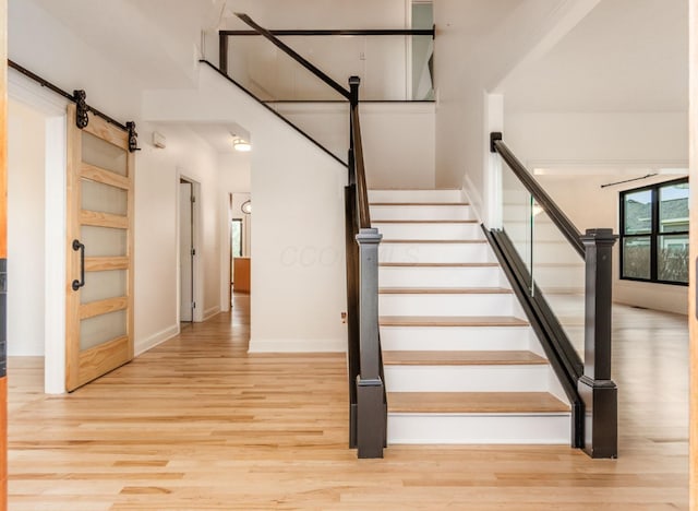 4175 Bangle Ct, Dublin, OH 43016 - stairway featuring wood finished floors, baseboards, and a barn door