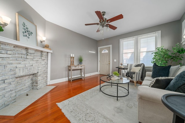 1542 S 4th St, Columbus, OH 43207 - living area featuring a fireplace, wood finished floors, ceiling fan, and baseboards