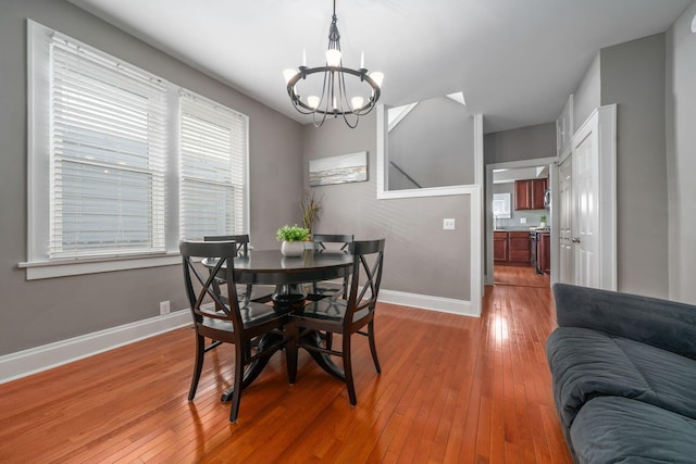 1542 S 4th St, Columbus, OH 43207 - dining area featuring light wood finished floors, a chandelier, and baseboards