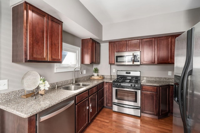 1542 S 4th St, Columbus, OH 43207 - kitchen with light stone countertops, stainless steel appliances, light wood finished floors, and a sink