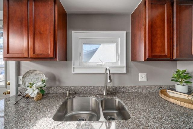 1542 S 4th St, Columbus, OH 43207 - kitchen with dark stone counters, reddish brown cabinets, and a sink