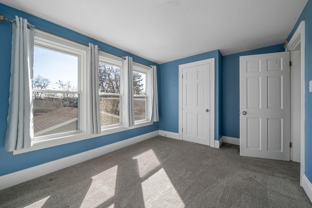 1542 S 4th St, Columbus, OH 43207 - unfurnished bedroom with a closet, baseboards, vaulted ceiling, and carpet floors