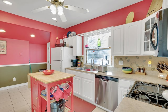 123 Campbell St, Delaware, OH 43015 - kitchen with a sink, freestanding refrigerator, black microwave, dishwasher, and white cabinets