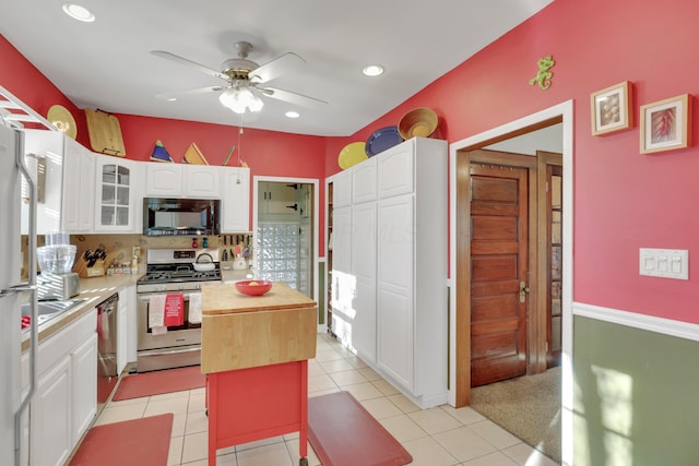 123 Campbell St, Delaware, OH 43015 - kitchen featuring stainless steel appliances, a center island, ceiling fan, white cabinets, and glass insert cabinets