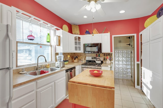 123 Campbell St, Delaware, OH 43015 - kitchen featuring a sink, a ceiling fan, appliances with stainless steel finishes, a center island, and white cabinets