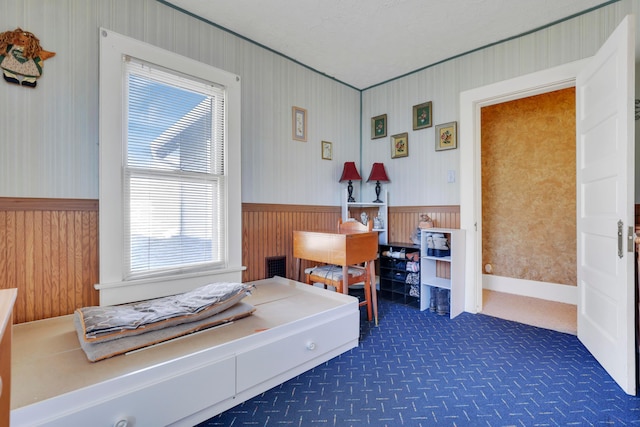123 Campbell St, Delaware, OH 43015 - bedroom featuring dark carpet, visible vents, wallpapered walls, and wainscoting