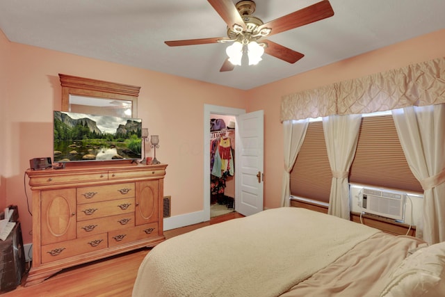 123 Campbell St, Delaware, OH 43015 - bedroom with cooling unit, a walk in closet, light wood-type flooring, baseboards, and visible vents