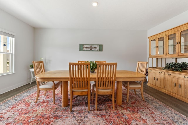 dining area featuring baseboards and wood finished floors
