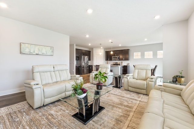 living area with wood finished floors, baseboards, and recessed lighting