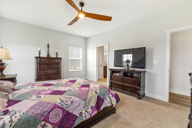 bedroom featuring a ceiling fan, baseboards, and light colored carpet