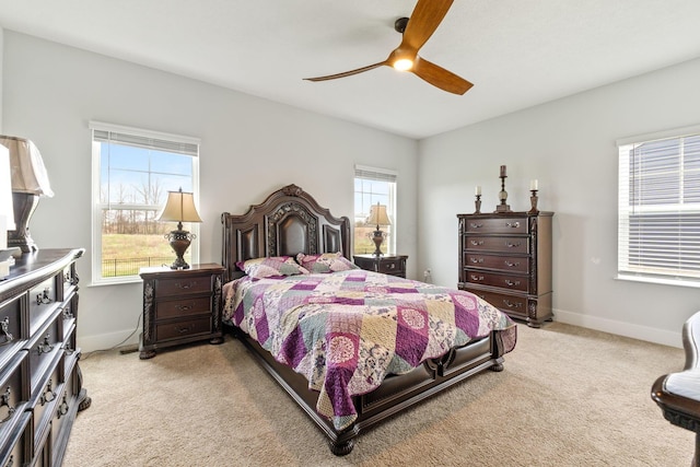 bedroom featuring light carpet, baseboards, and ceiling fan