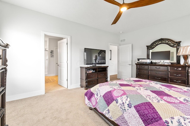bedroom featuring carpet flooring, baseboards, connected bathroom, visible vents, and a ceiling fan