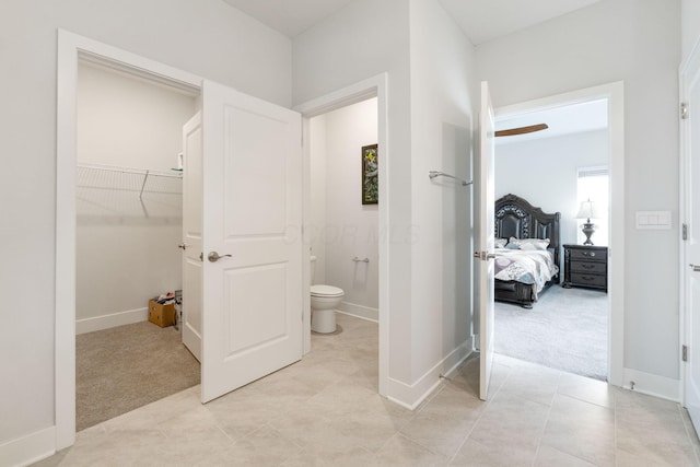 interior space with light tile patterned flooring, light colored carpet, and baseboards