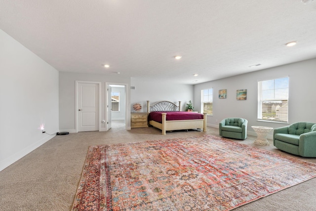 bedroom featuring baseboards, a textured ceiling, recessed lighting, and light carpet