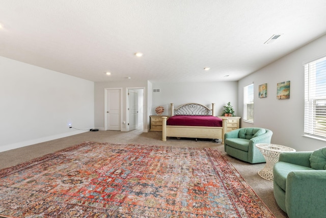bedroom featuring light colored carpet, visible vents, and baseboards