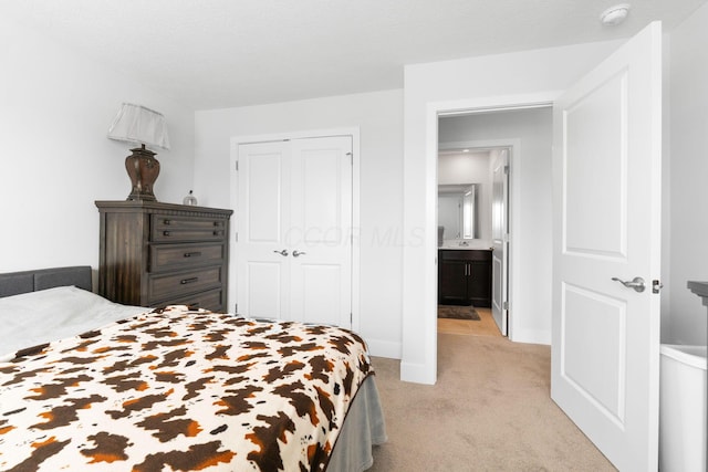 bedroom with light carpet, baseboards, and a closet
