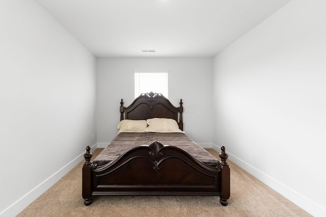 carpeted bedroom with baseboards and visible vents