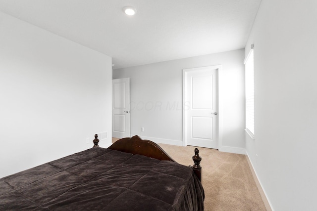 carpeted bedroom featuring baseboards