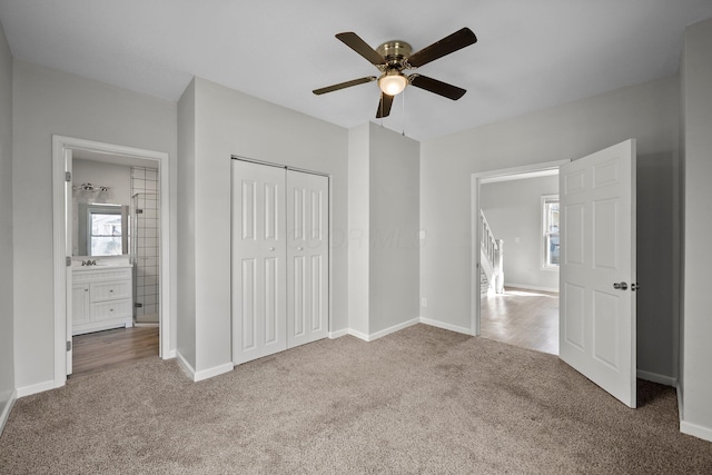 unfurnished bedroom featuring carpet flooring, a ceiling fan, a closet, and baseboards