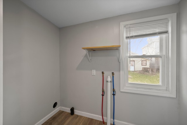 washroom featuring dark wood-style floors, baseboards, and laundry area