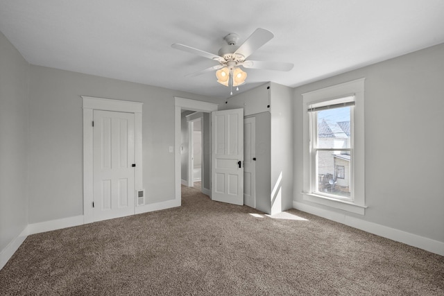 unfurnished bedroom with baseboards, carpet floors, a closet, and a ceiling fan