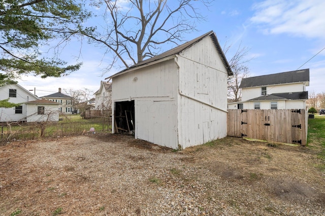 view of outbuilding featuring an outbuilding and fence