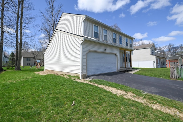 exterior space with a garage, driveway, and a front lawn