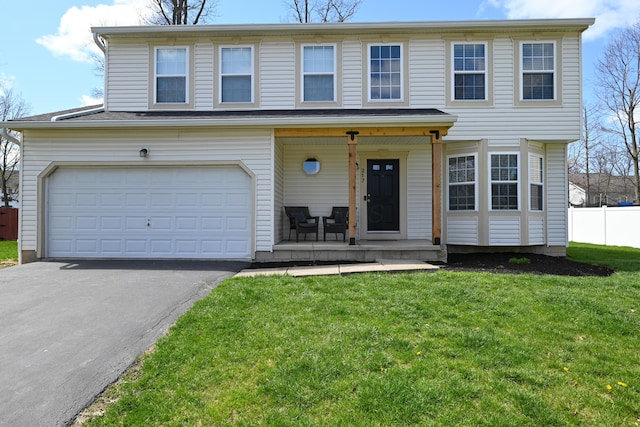 view of front of home featuring an attached garage, aphalt driveway, a front lawn, and a porch