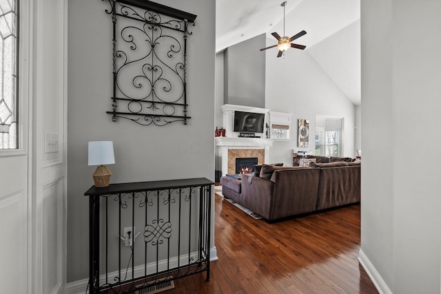 4600 Hirth Hill Rd E, Grove City, OH 43123 - living area with high vaulted ceiling, dark wood-type flooring, baseboards, ceiling fan, and a fireplace