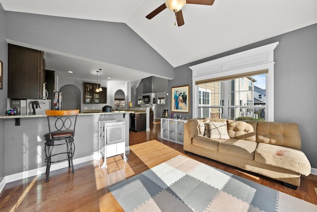 4600 Hirth Hill Rd E, Grove City, OH 43123 - living area with lofted ceiling, wood finished floors, arched walkways, and ceiling fan