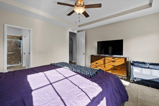 4600 Hirth Hill Rd E, Grove City, OH 43123 - carpeted bedroom with a tray ceiling, ensuite bath, and ceiling fan