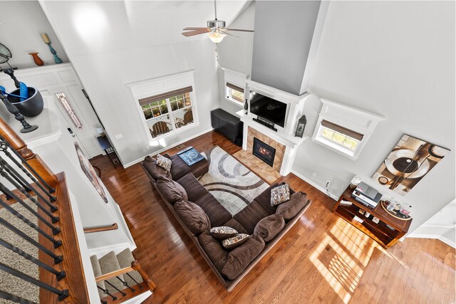 4600 Hirth Hill Rd E, Grove City, OH 43123 - living area featuring stairs, high vaulted ceiling, a ceiling fan, wood finished floors, and a high end fireplace