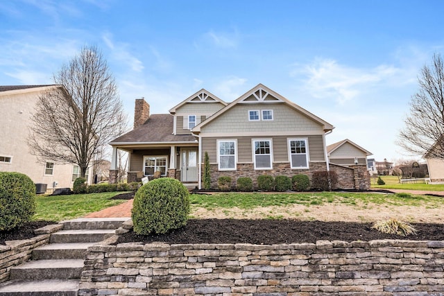 4600 Hirth Hill Rd E, Grove City, OH 43123 - craftsman-style home with stone siding, a chimney, and covered porch