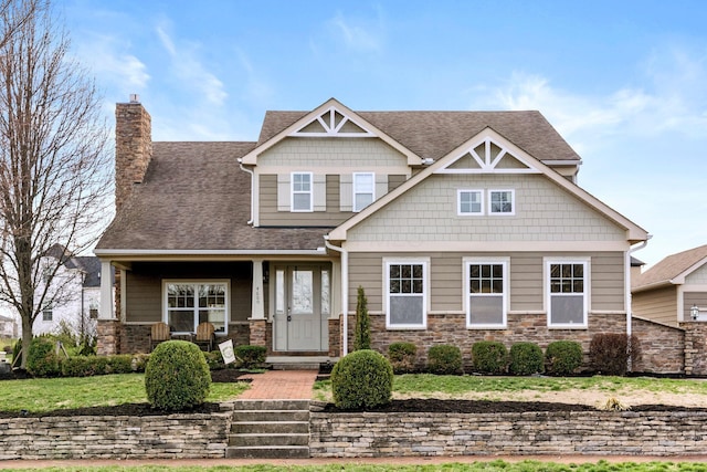 4600 Hirth Hill Rd E, Grove City, OH 43123 - craftsman inspired home featuring a chimney, a front yard, stone siding, and roof with shingles