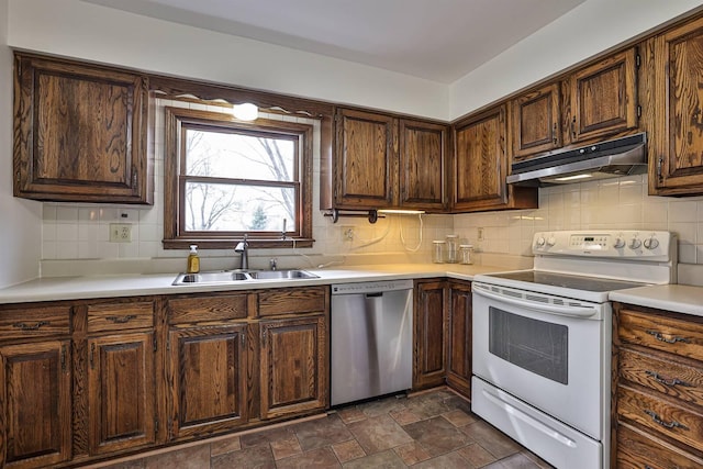 kitchen with light countertops, under cabinet range hood, white electric range oven, dishwasher, and a sink